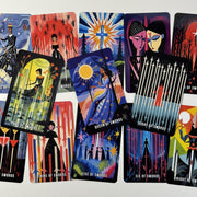 May include: A collection of tarot cards featuring colorful illustrations. The cards display various scenes with figures, celestial bodies, and geometric designs. The cards include text such as "Page of Swords," "Queen of Swords," and "Eight of Swords."